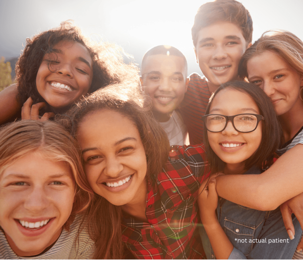teenagers hugging and smiling at the camera