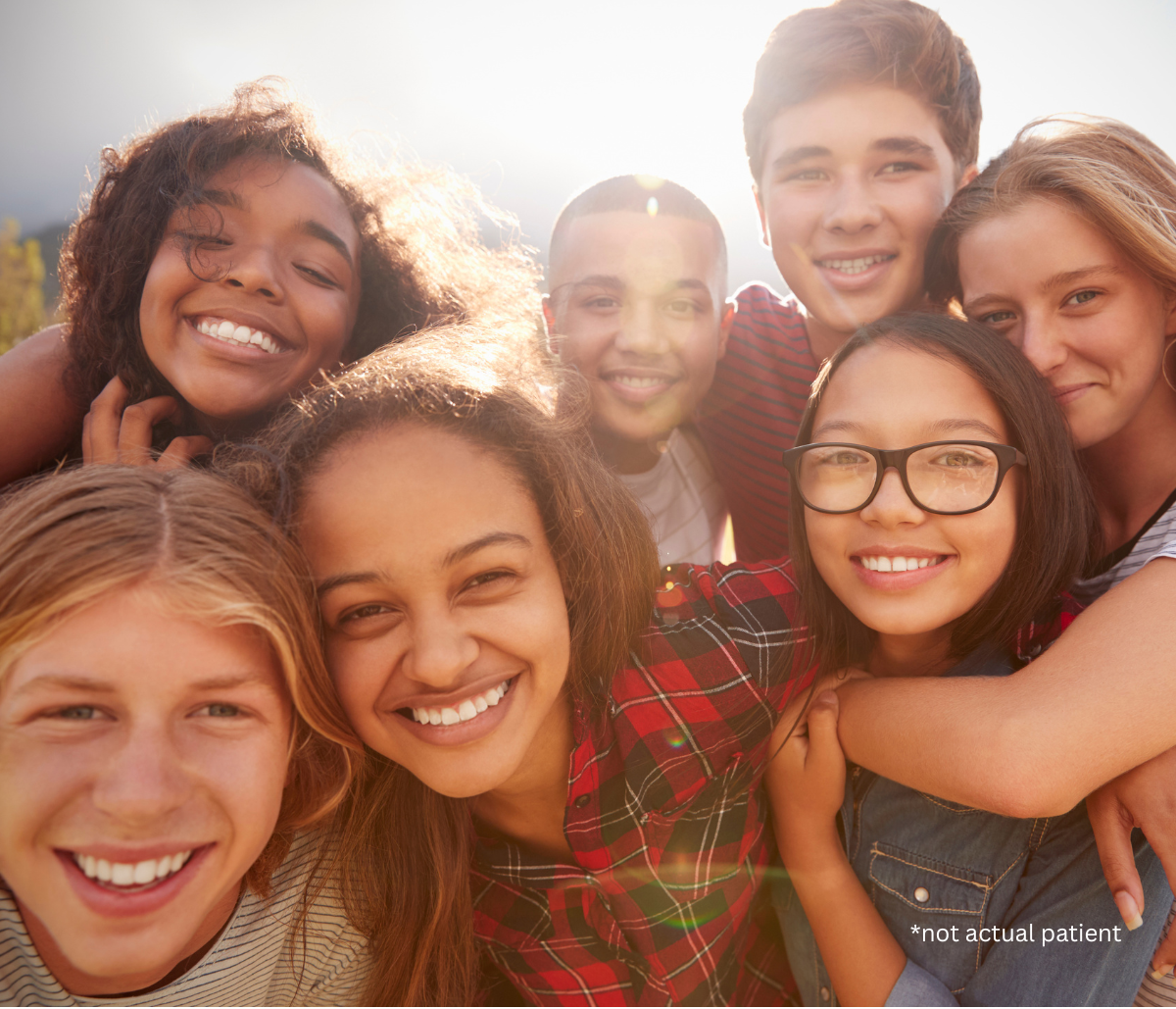 teenagers hugging and smiling at the camera